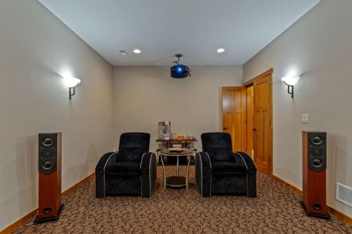 Movie room with heated floors, projector and wall sconces