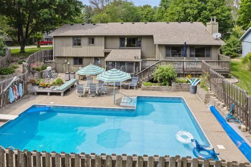 Stunning backyard oasis with heated, underground pool, screen porch, gilling station, deck and tons of fun!