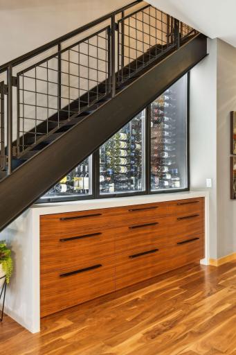 Custom temperature controlled Wine Cellar featuring Cambria Quartz and custom cabinetry for bar storage and other essentials