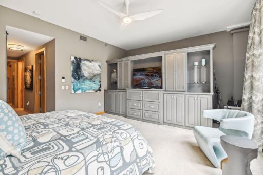 Primary Suite with expansive space featuring floating custom cabinetry and space behind to be utilized as an additonal walk-in closet or storage