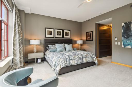 Primary Suite features expansive space and large windows with views of the downtown neighborhood of the Mill District