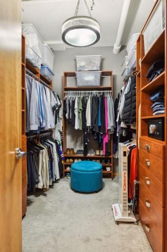 Extra-Large Primary Suite Closet with custom built-in from California Closets