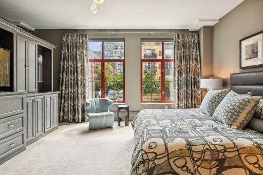 Primary Suite with oversized windows, fully electric Lutron shades and custom drapery