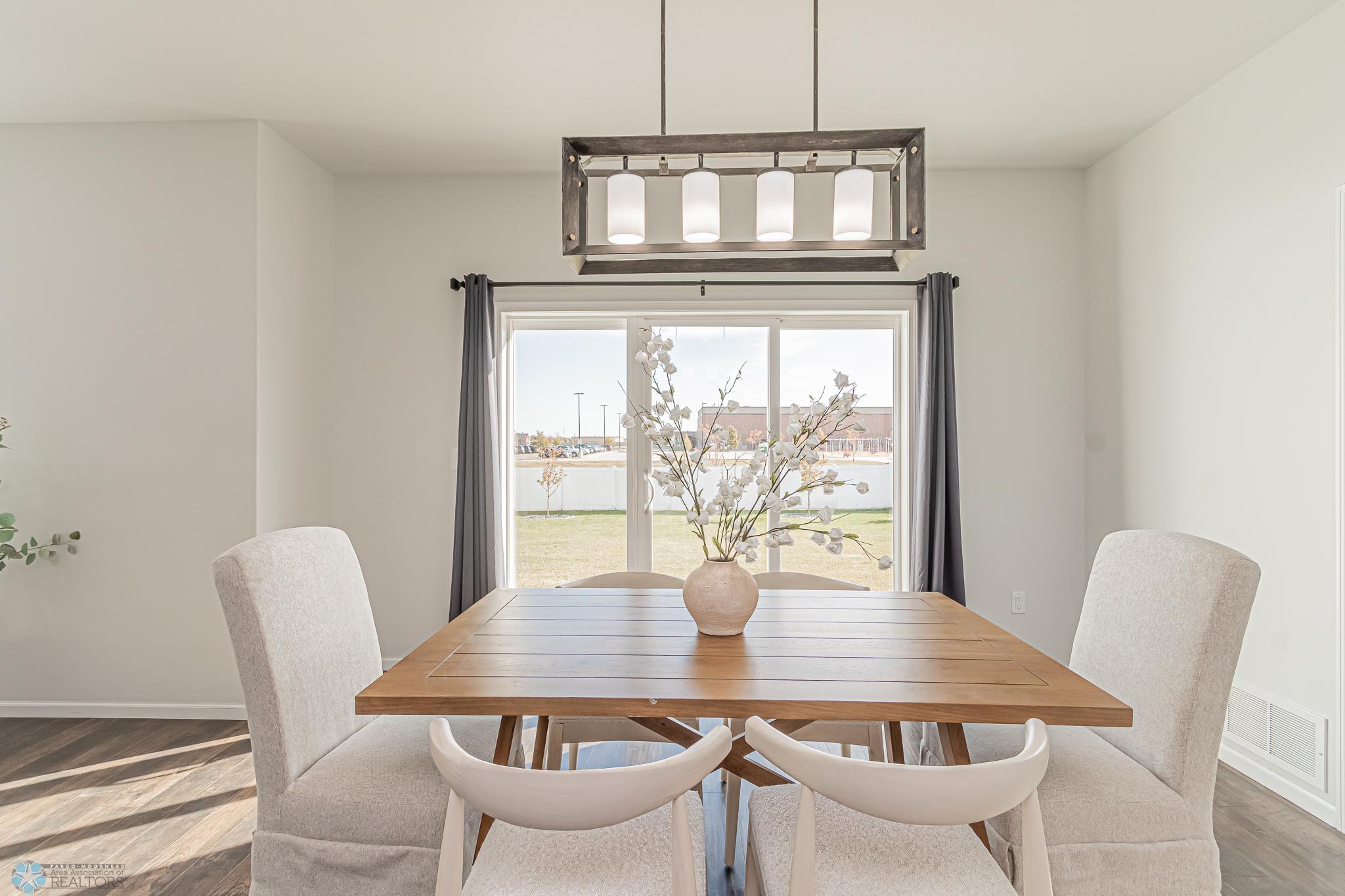Dining Area with access to Patio & a Vinyl-Fenced backyard