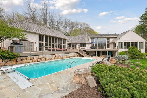 Spectacular Minnetrista home with a resort-like pool and several entertaining spaces that overlook 3 acres of serene nature.