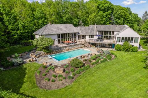 Spectacular Minnetrista home with a resort-like pool and several entertaining spaces that overlook 3 acres of serene nature.