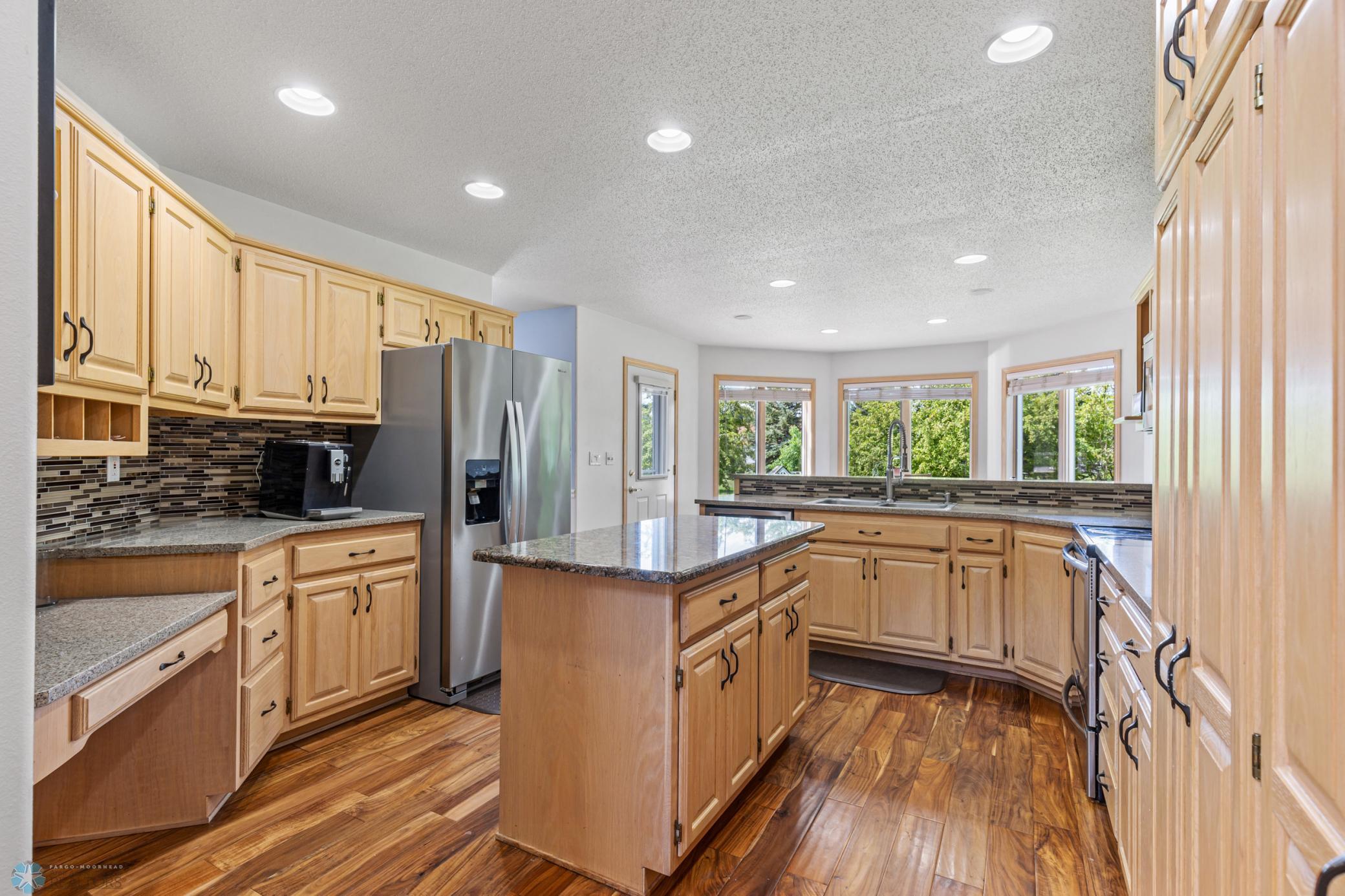 Kitchen with Stainless Appliances Granite Countertops and Tile Backsplash.jpg