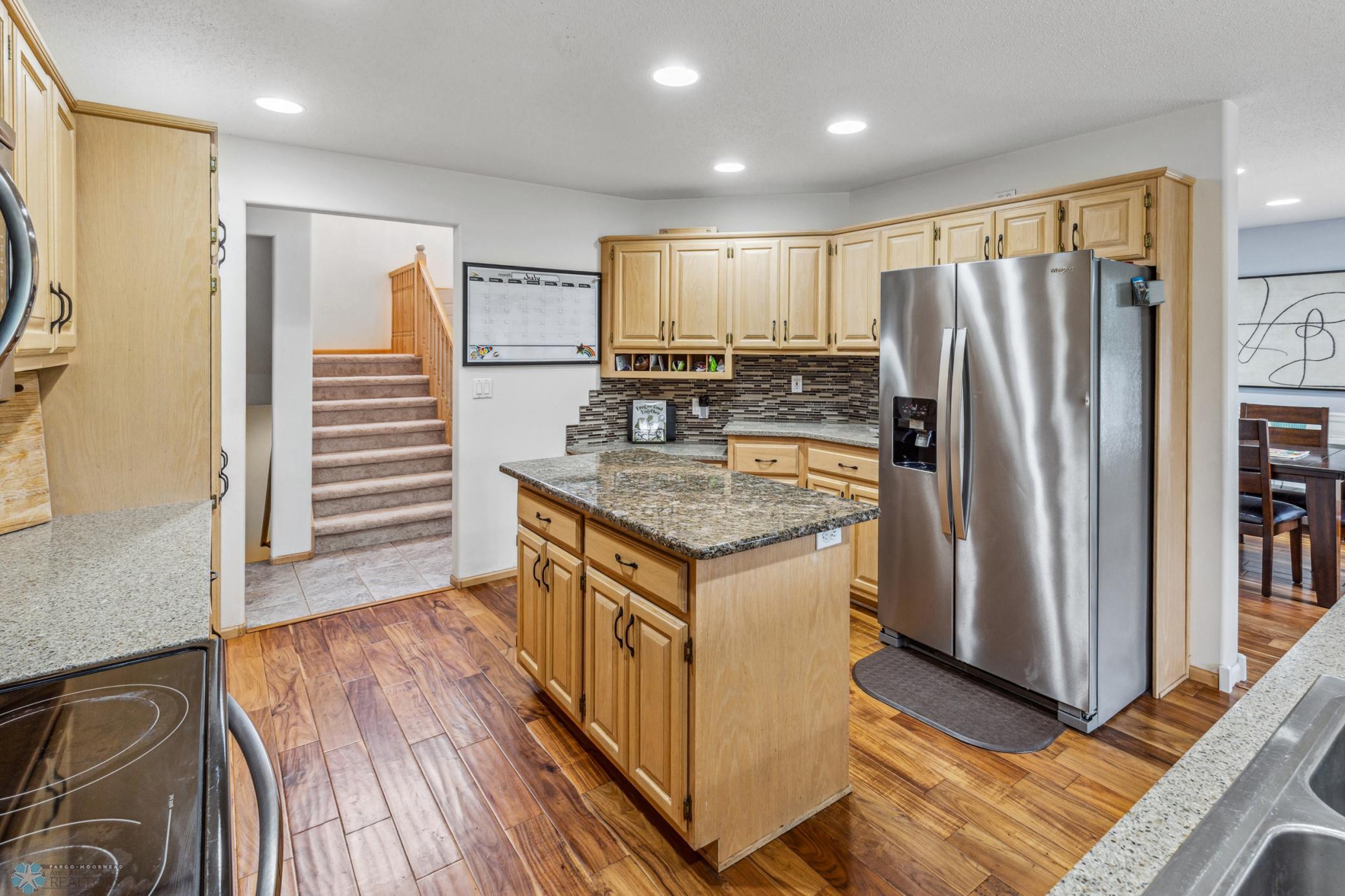 Kitchen with Stainless Appliances Granite Countertops and Tile Backsplash
