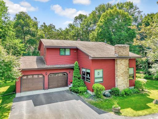 Country Style Two Story surrounded by mature woods and an abundance of nature.