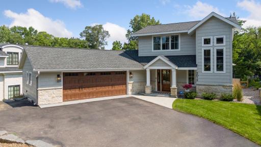 A beautiful wood paneled garage door offers additional curb appeal.
