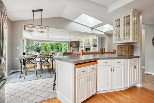 Kitchen opens up to a spacious family room drenched in natural light.