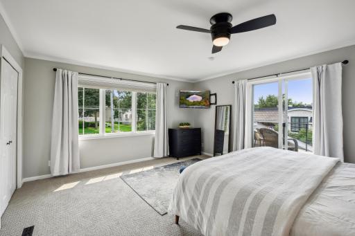 Primary bedroom offers a private balcony overlooking the channel and Lake.