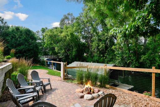 A new paver patio installation with a firepit is fenced while taking full advantage of the Private views of the channel create a lakeside oasis.