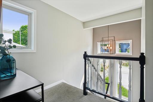 Fabulous stairwell with new carpet and light fixtures.
