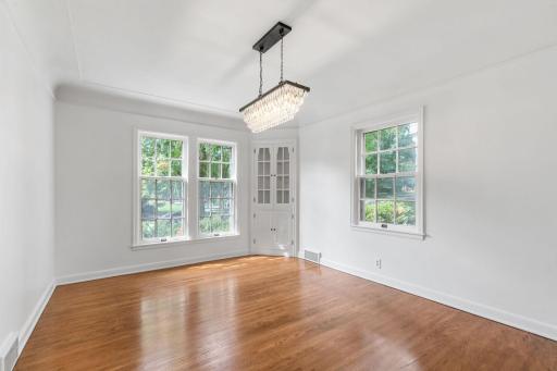 The Dining Room features a pair of built-in china cabinets, coved ceilings w/ molding and oak hardwood flooring