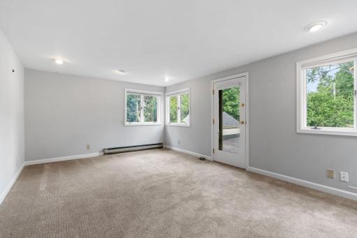 Upper level Bonus Room offers a full glass entry door w/ access to the balcony and an abundance of windows which provide panoramic views
