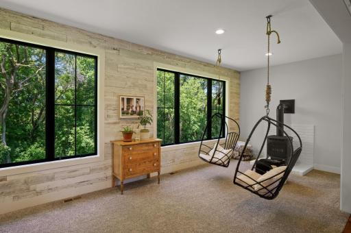 Adjacent to the great room is the four-season porch, accessible through custom steel 4-lite barn doors.