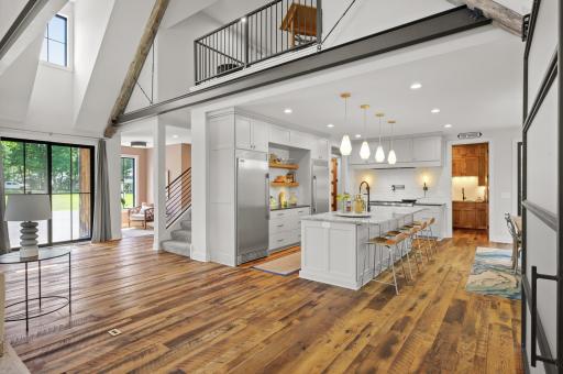 The beautiful elegant kitchen features extensive cabinetry, Brazilian Quartzite and Granite countertops.