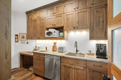 Steps from the kitchen is the walk-thru butler pantry, featuring an extra sink, Bosch full-size dishwasher, and ample storage.