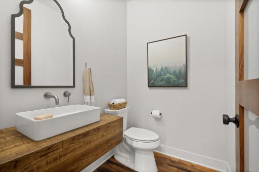 Completing the main level is a powder bathroom featuring a stylish floating vanity.