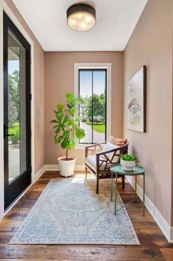 Welcoming front foyer upon entry - Black Andersen 400 windows, recessed lighting, 8' custom Black Walnut, 9-foot ceilings and glass 5-lite doors throughout main level.