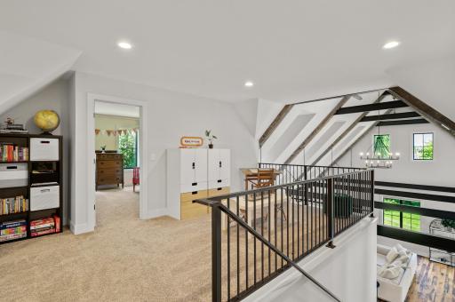The versatile upper-level loft overlooks the main level â ideal for a playroom or reading nook.
