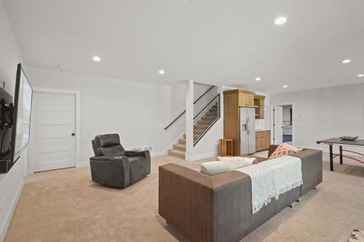 The lower-level walkout family room is an entertainer's dream featuring 9-foot ceilings, and in-floor heat.