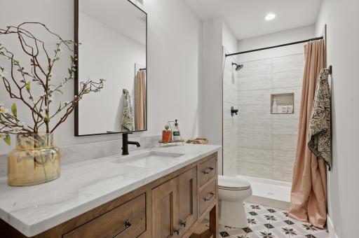 Just steps away is the shared three-quarter bathroom with a walk-in shower stall.