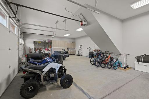5-car attached heated garage - fully finished with in-floor drains, storage, and dog washing station.