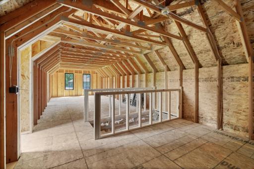 Newly built stairs in the garage leads you to the unfinished bonus loft.