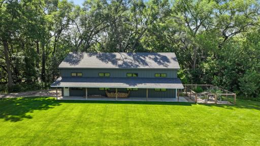 The expansive 60 x 30 outbuilding serves as a great workshop, extra garage storage, or more! 2-car garage door, and a covered outdoor porch next to the fenced-in garden.