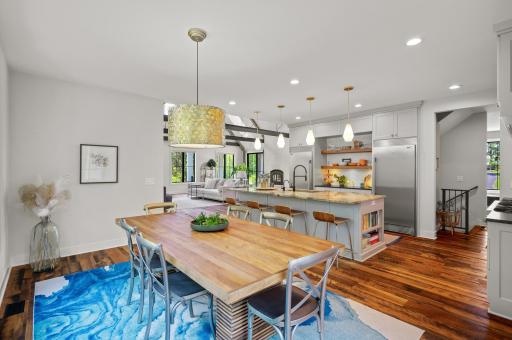 The adjoining informal dining space, with a stylish chandelier, provides easy access to the back deck â perfect for entertaining!