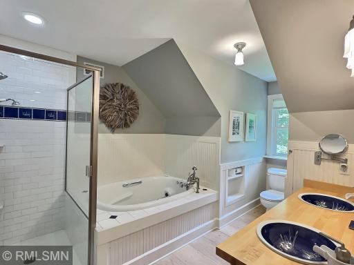 Relax in a the jetted tub, this full bathroom is located in the upper level and is finished with a double vanity.