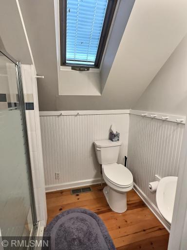 The bunkhouse is complete with a three-quarter bathroom offering wainscoting and wood flooring.