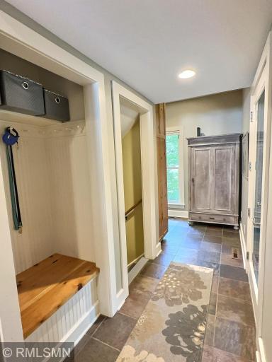 Just off the side deck near the detached garage is a mud room with a custom built-in locker with storage.