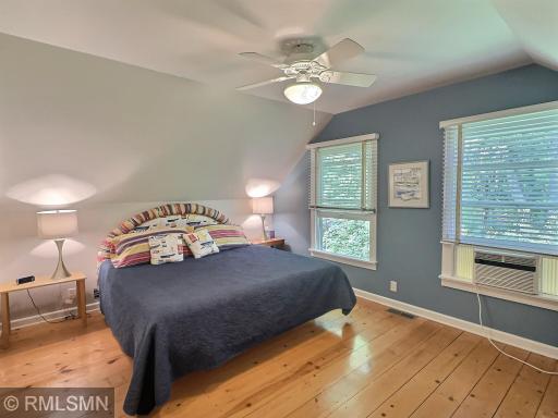 With wood flooring, double windows and ceiling fan, the bedroom in the bunkhouse is the perfect quiet space.