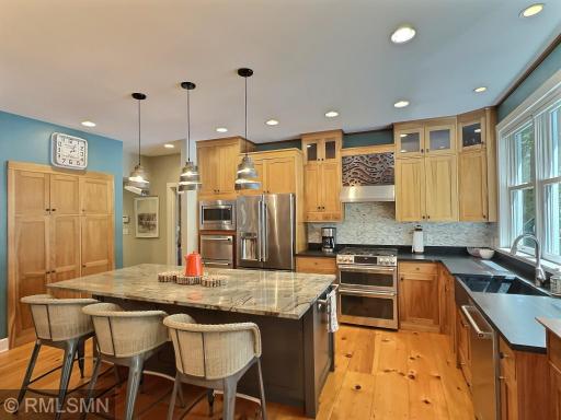 The kitchen offers a large built-in pantry, pendant lights, double oven and additional built-in fridge drawers.