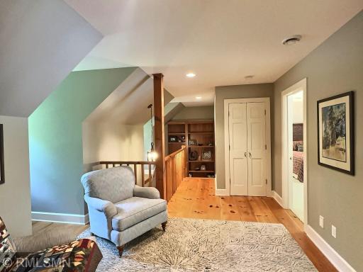 Another view of the upper level den with a linen closet, there is also a bookshelf built-in to the staircase.