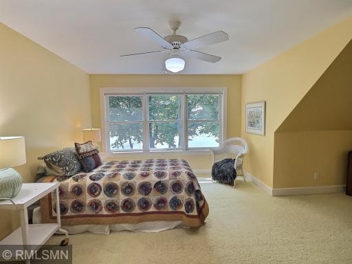 Also located in the upper level, this bedroom is also very spacious with a ceiling fan, closet and lake views.