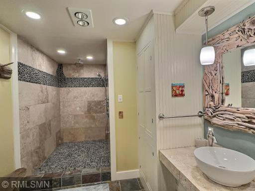 The lower level has a three-quarter bathroom with a massive walk-in shower finished with great tile accents.