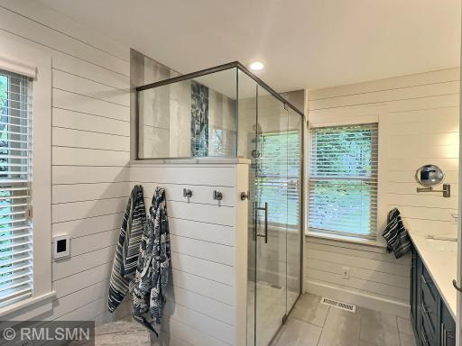 Live in luxury with a three-quarter private bathroom with a walk-in glass shower with amazing tile accents.