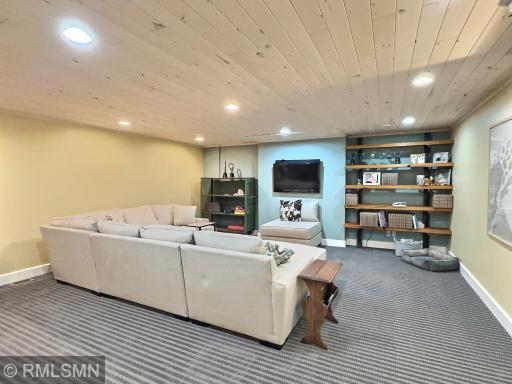 Spread out with a lower level, the family room is very spacious with custom built-in shelves and carpet.