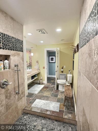 Another view of the lower level bathroom, with slate flooring and a large counter...perfect for coming off the lake.