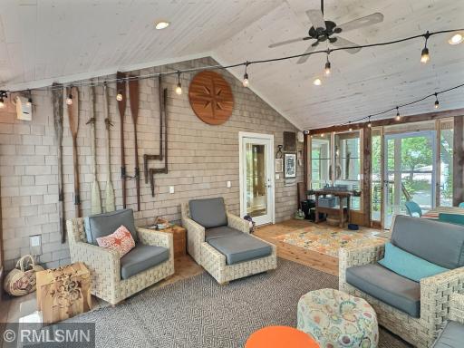 The screen porch offers vaulted ceilings, ceiling fan, shake accents and opens to front and back decks.