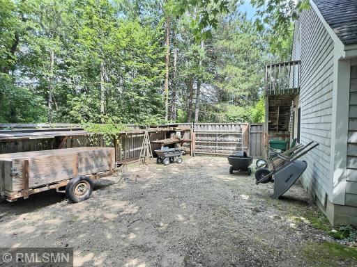 Alongside the triple garage is a fenced in area ideal for trailers, gardening tools...offers great outdoor storage.