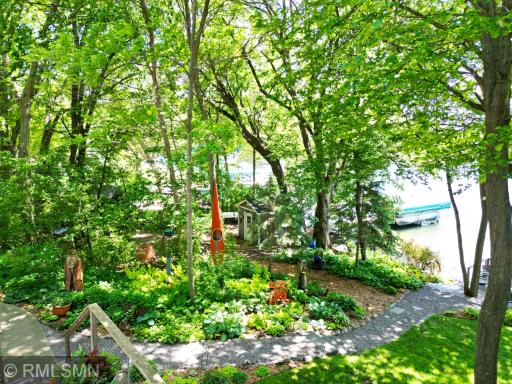 Beautifully landscaped walkway leads to the sandy shoreline, imagine your summer days spent on Lake Sylvia.