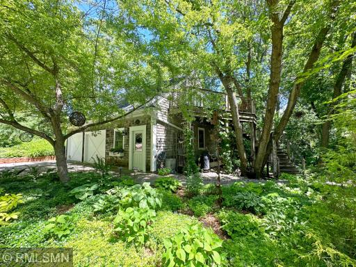 View of the detached garage with stairs leading to the bunkhouse, almost feels like it could be a treehouse.