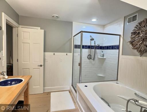 Just down the hall from the two upstairs bedrooms, this bathroom has shiplap and tile accents throughout.