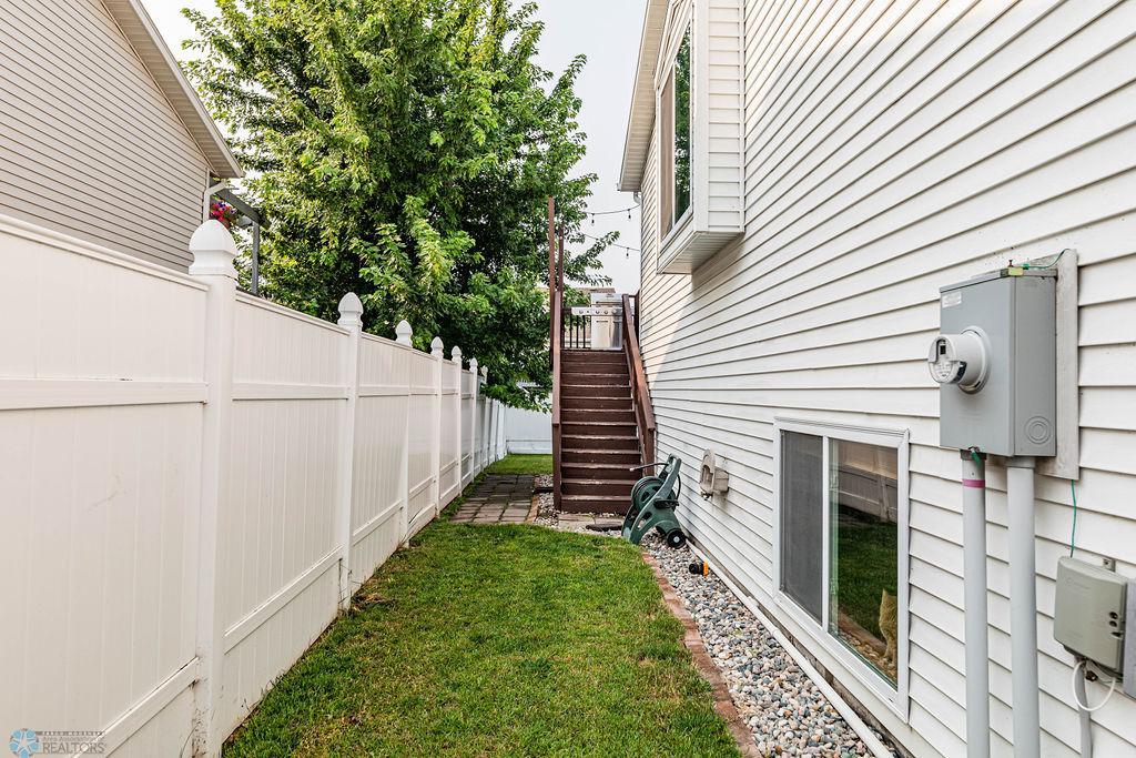 Side steps down to Fenced Backyard