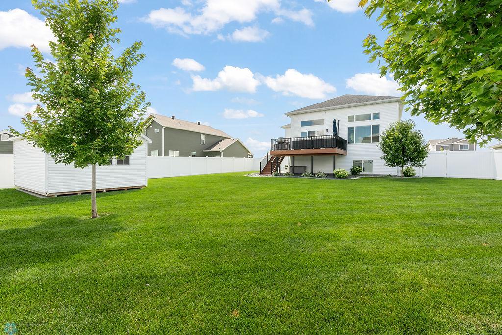 Backyard: sprinklers, low maintenance privacy fence, professional landscaping